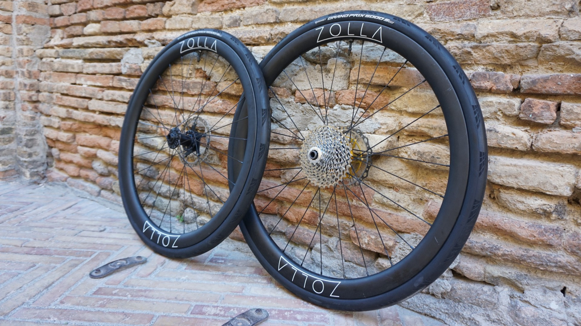Zolla wheels leaning against a brick wall